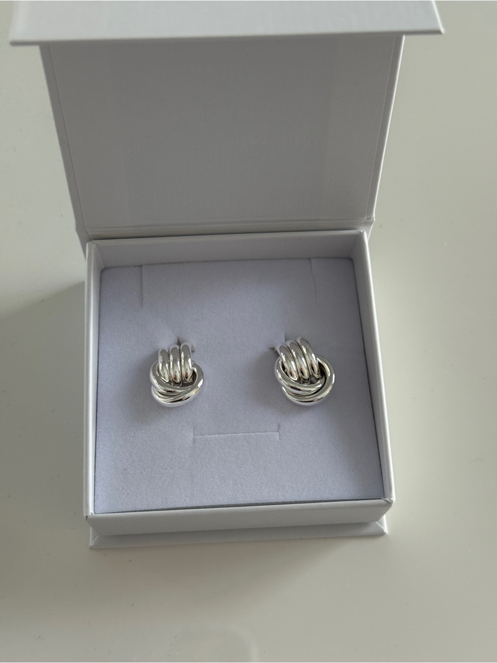 Heaven mayhem baby silver knot earrings